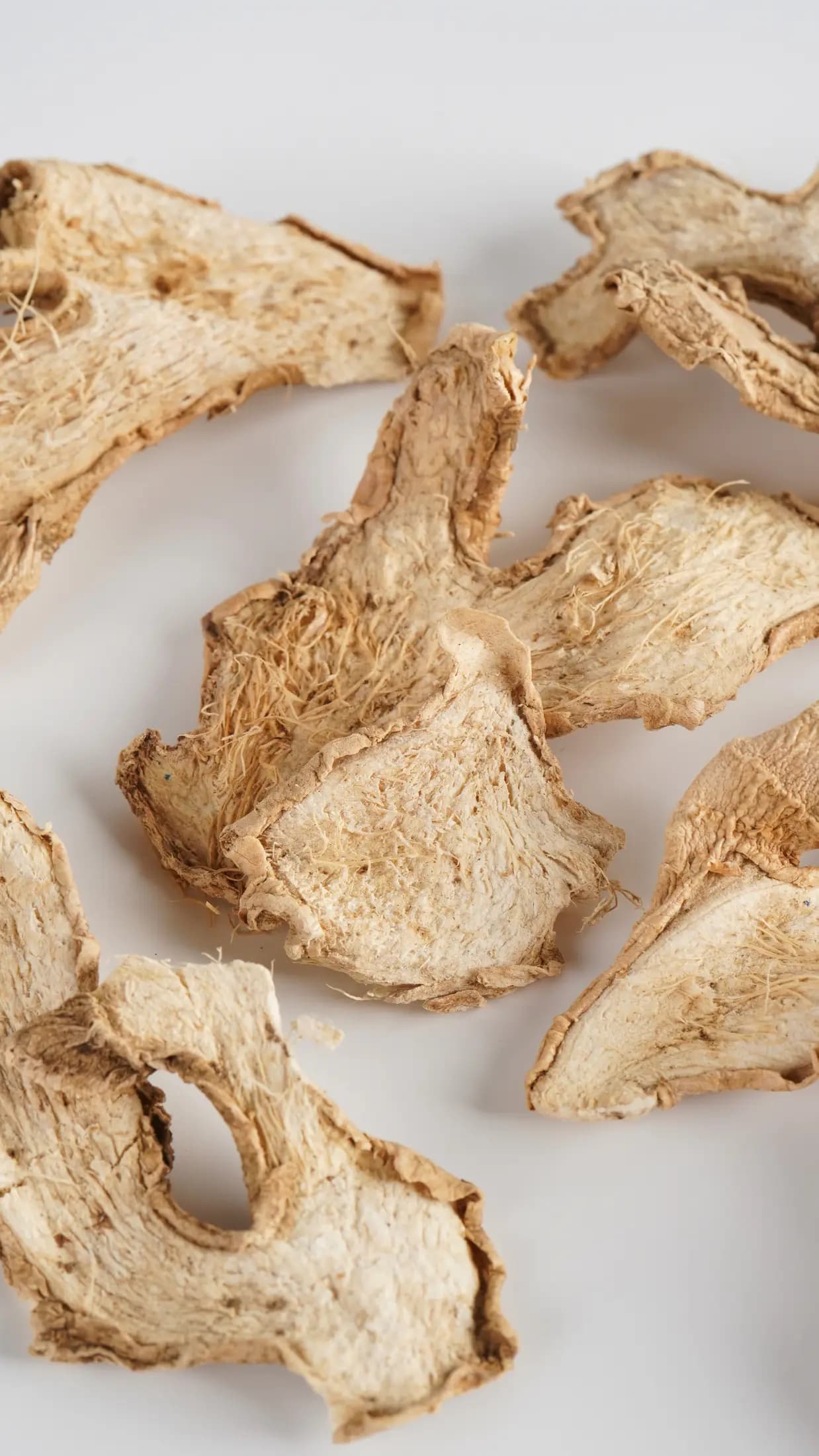 Dried Jahe Gajah slices photographed on a plain ground
