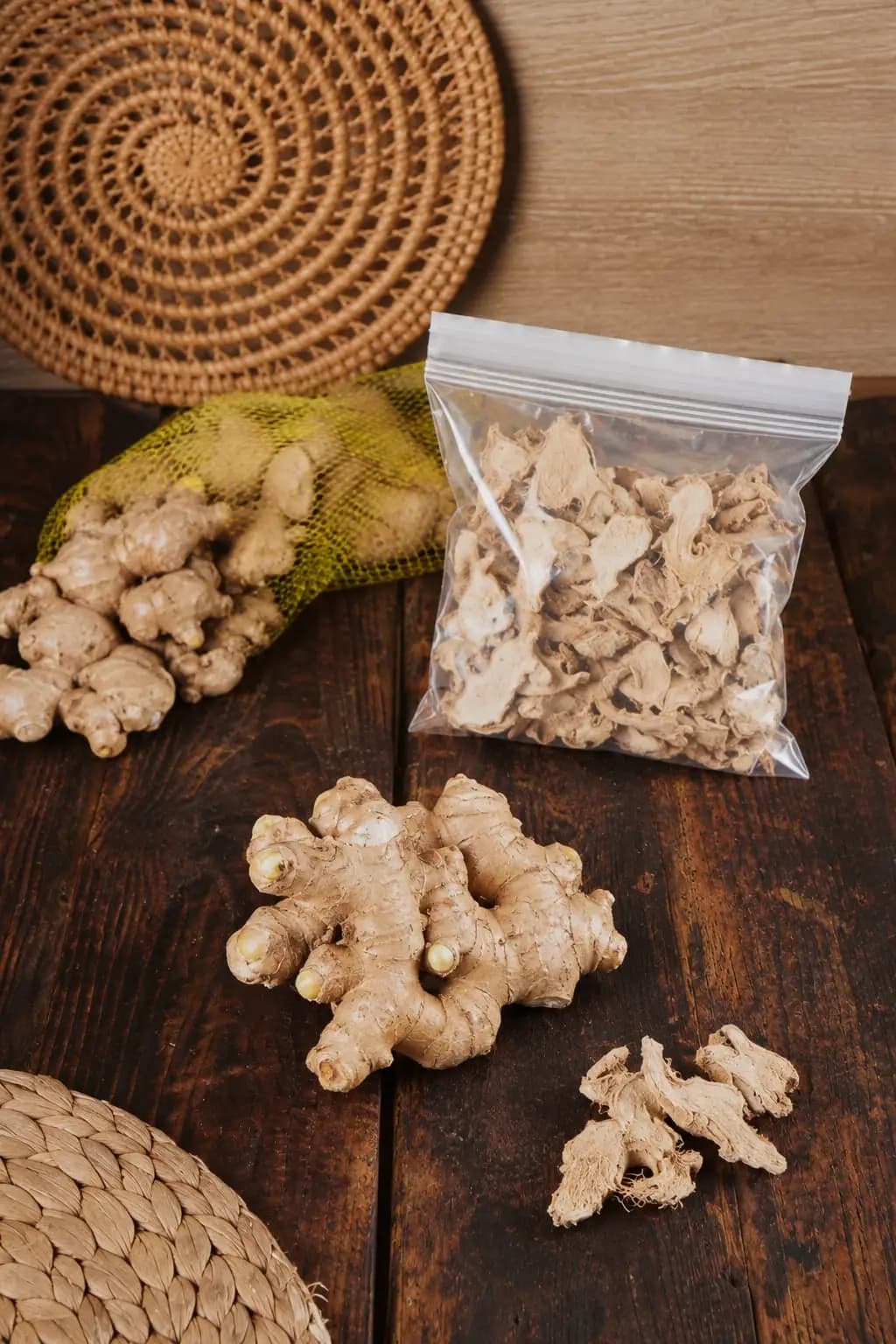 Jahe Gajah in export netting beside bagged dried ginger on a wooden table